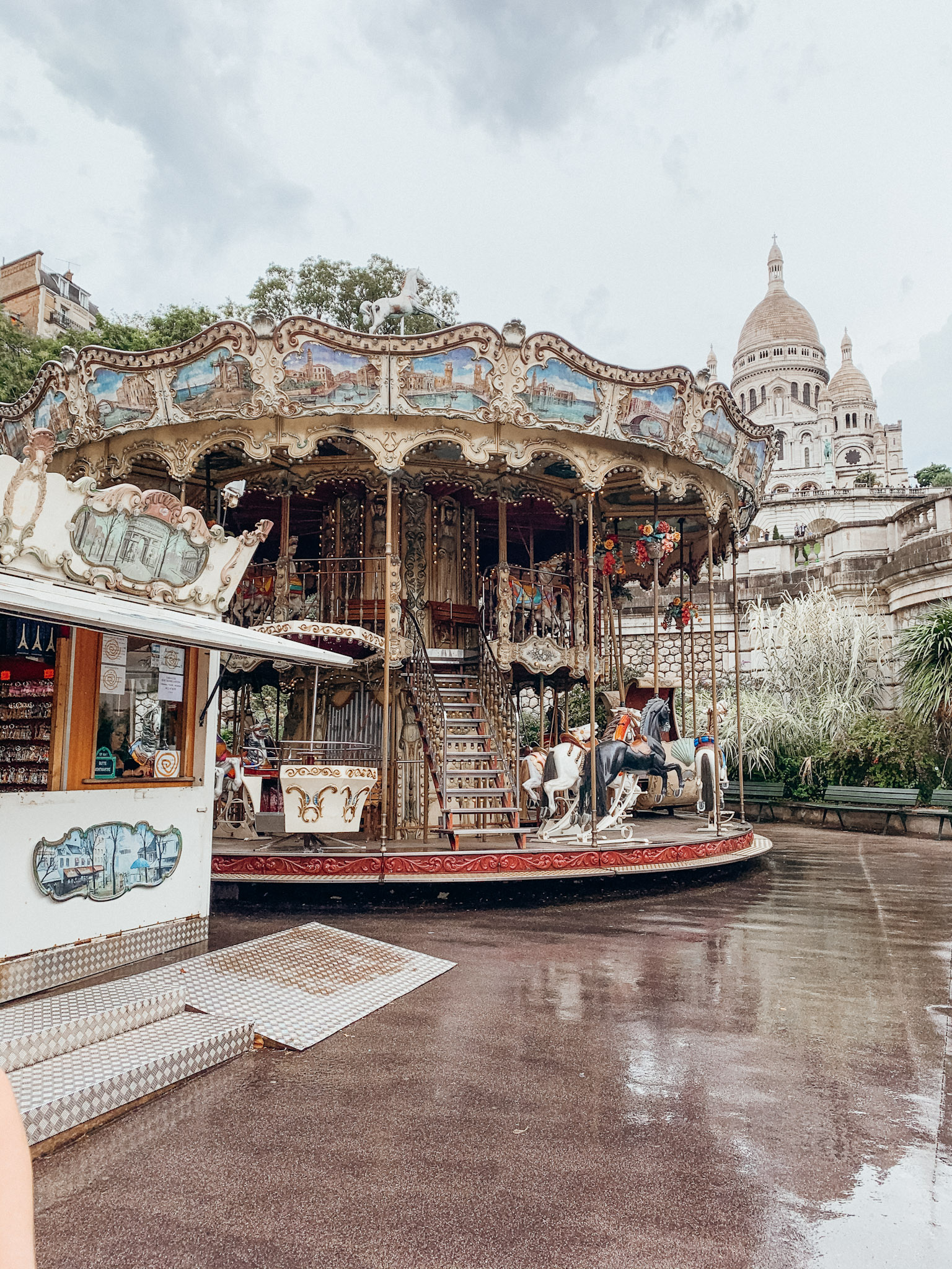 Vintage carousel in front of large white buildings with onion dome roofs- Montmartre in May in Pari